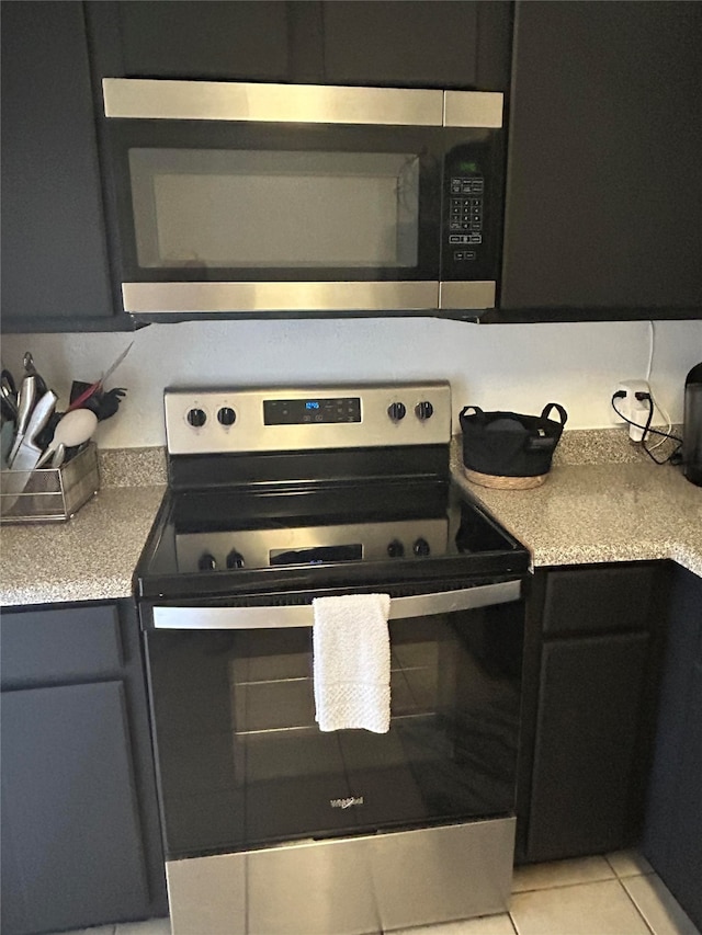 kitchen with appliances with stainless steel finishes and light tile patterned floors