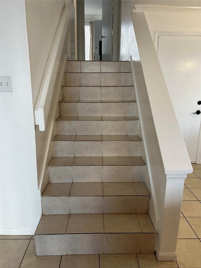 staircase featuring tile patterned floors