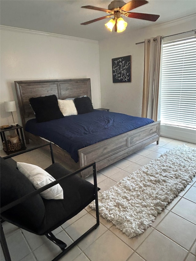 bedroom with ornamental molding, ceiling fan, and light tile patterned flooring