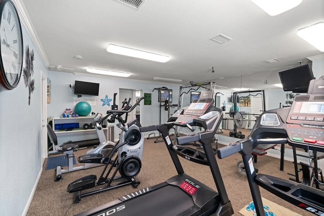 exercise room featuring a textured ceiling and ornamental molding