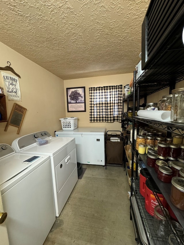 laundry area with a textured ceiling and washer and dryer