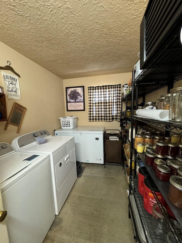 washroom with independent washer and dryer and a textured ceiling