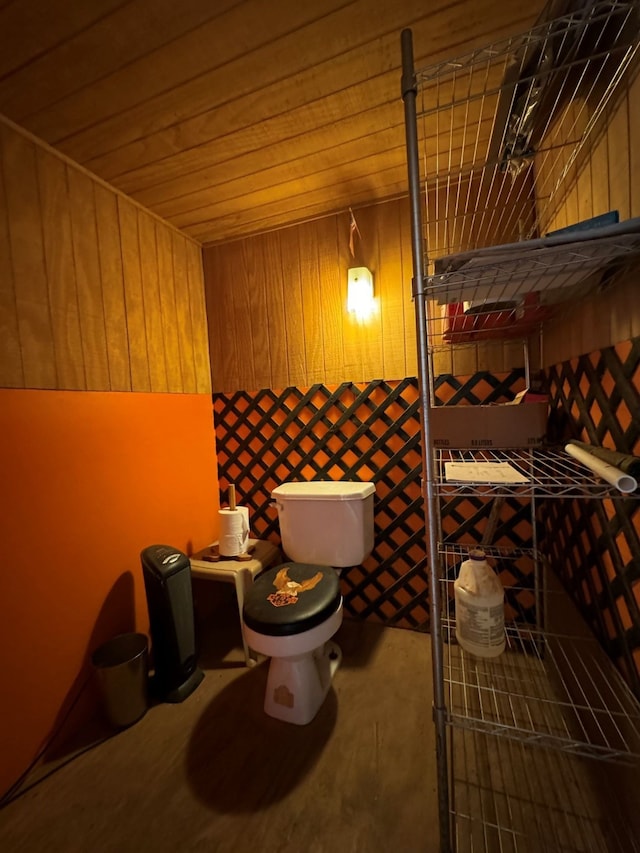 interior space featuring wood ceiling and toilet