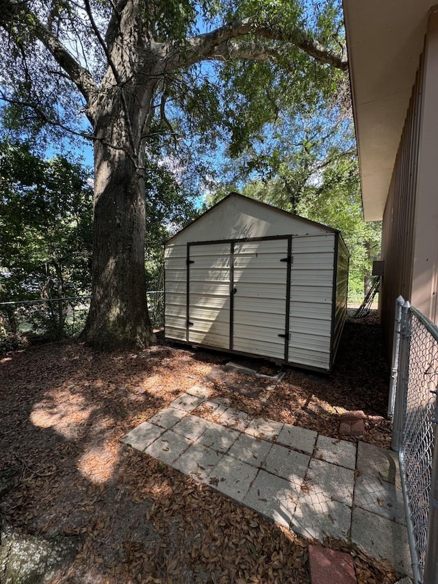 view of shed with fence