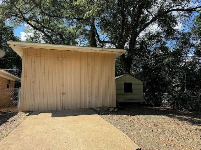 view of shed featuring fence