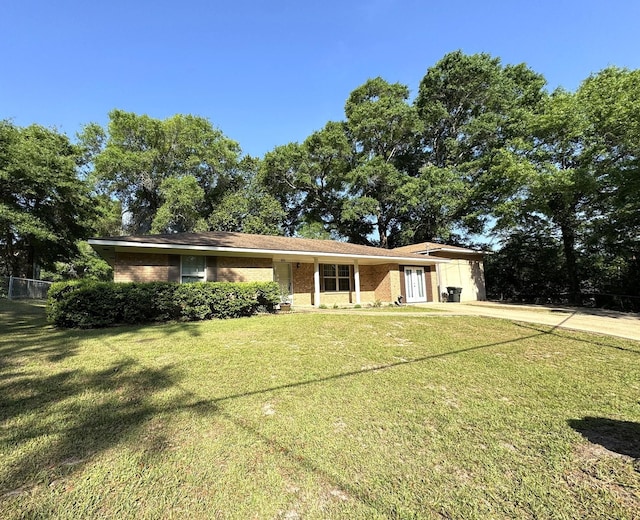 single story home with a front lawn and concrete driveway