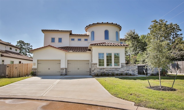 mediterranean / spanish home with a front yard