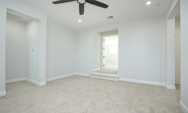 carpeted empty room featuring ceiling fan