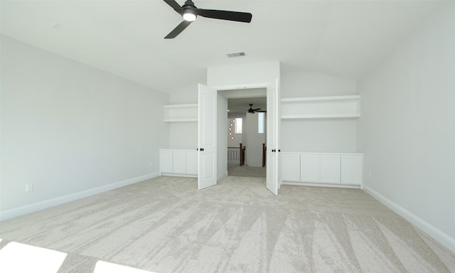 unfurnished bedroom featuring ceiling fan, light colored carpet, and lofted ceiling