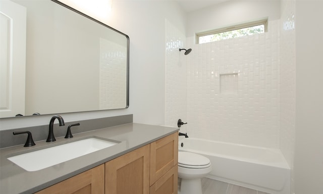 full bathroom featuring tiled shower / bath combo, vanity, and toilet