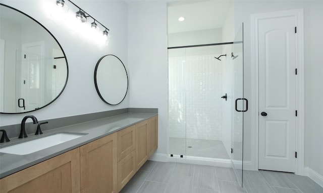 bathroom featuring vanity and an enclosed shower