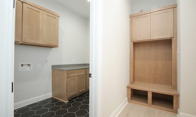 mudroom with dark tile patterned flooring