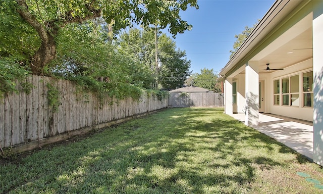 view of yard featuring ceiling fan and a patio area