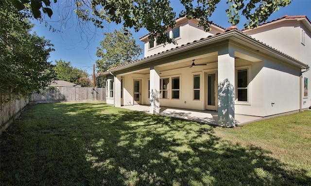 back of house featuring a yard, ceiling fan, and a patio area