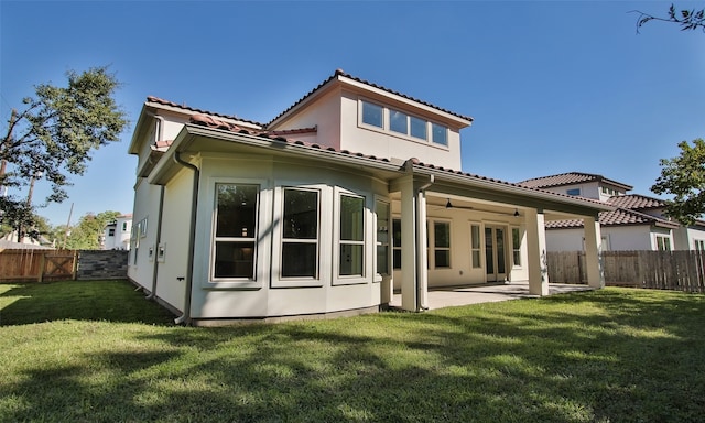 rear view of property with a patio area and a yard