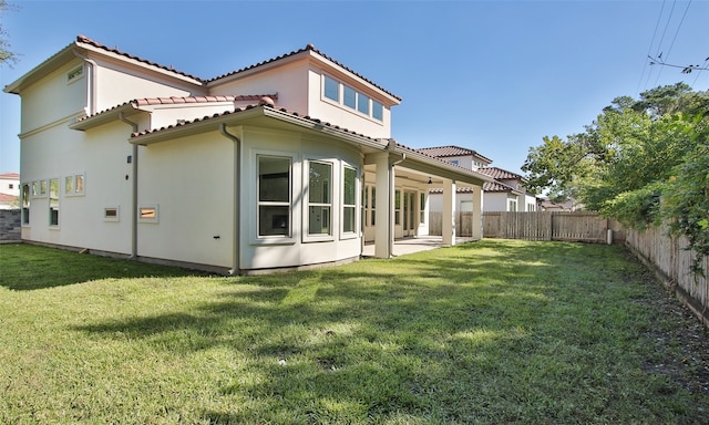 back of property featuring a yard and a patio area