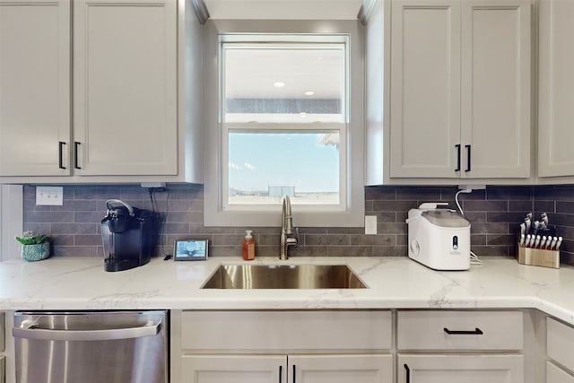 kitchen with sink, tasteful backsplash, and stainless steel dishwasher