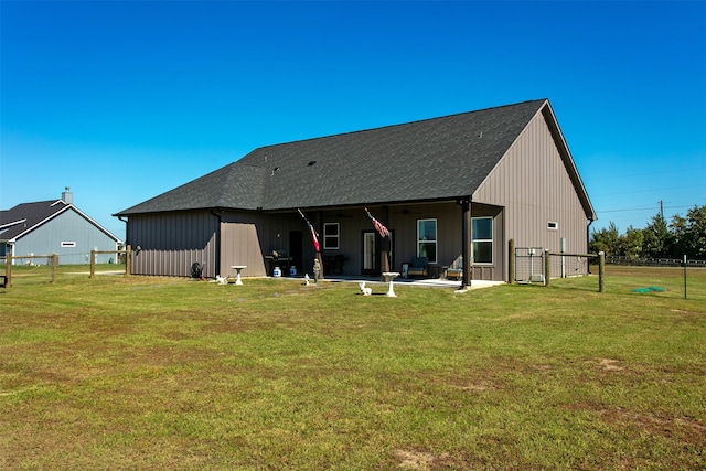 back of house with a yard and a patio area