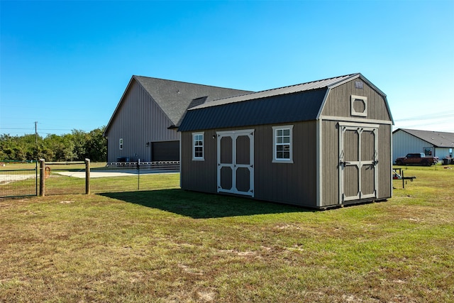 view of outdoor structure featuring a lawn