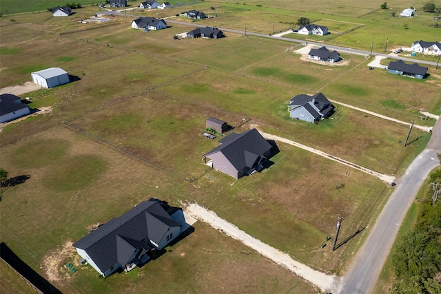 birds eye view of property with a rural view