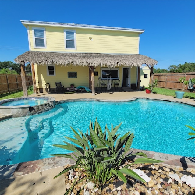 view of swimming pool featuring an in ground hot tub and a patio