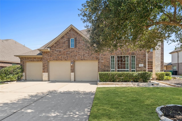 view of front of house featuring a front yard and a garage