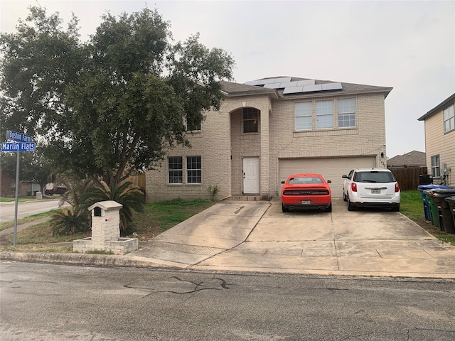 view of property with a garage and solar panels