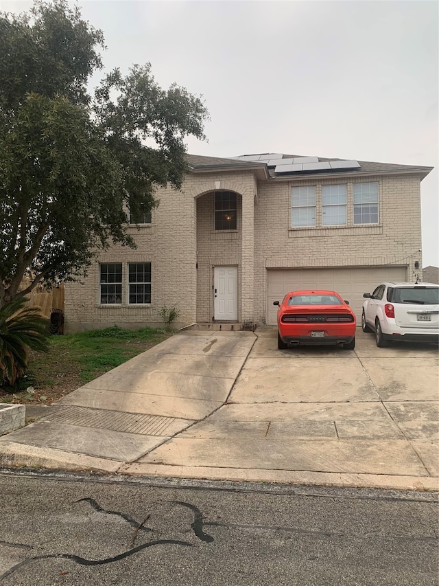 view of front of house with solar panels and a garage