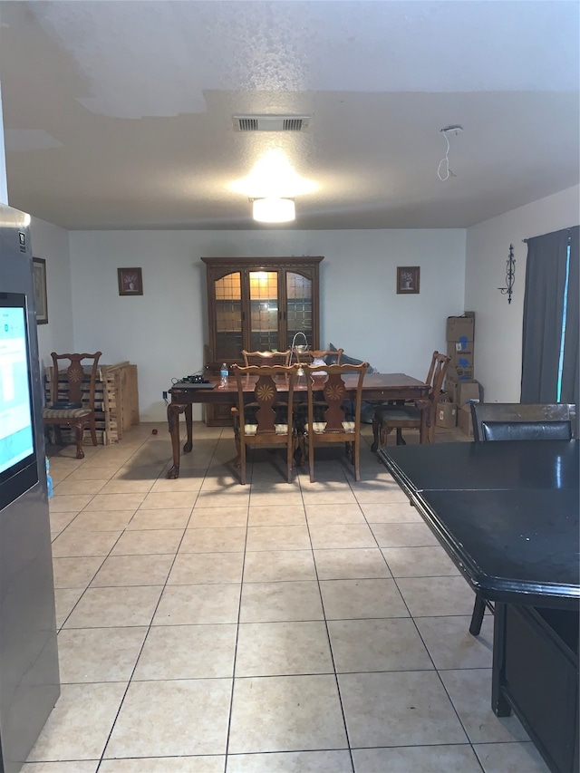 dining area with light tile patterned floors