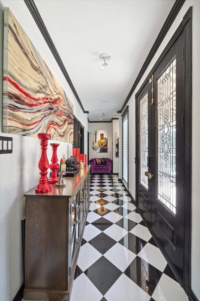 hall with ornamental molding, a wealth of natural light, and french doors