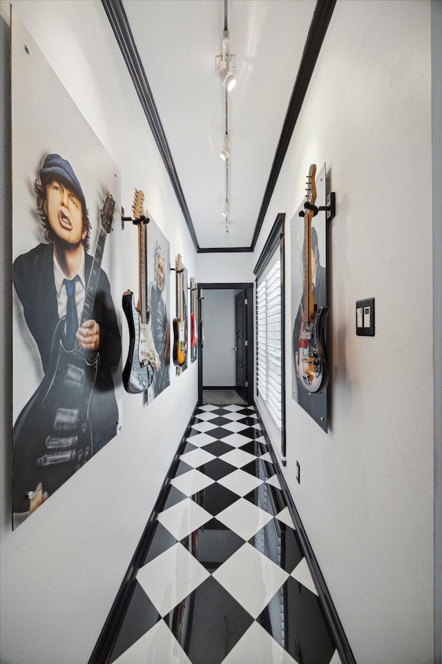 corridor featuring crown molding and track lighting