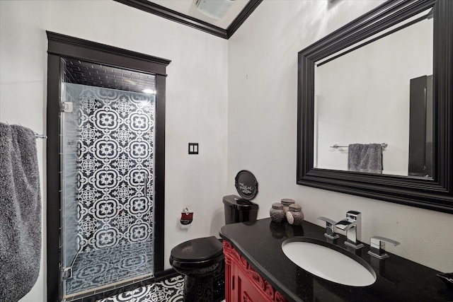 bathroom with vanity, toilet, walk in shower, and ornamental molding