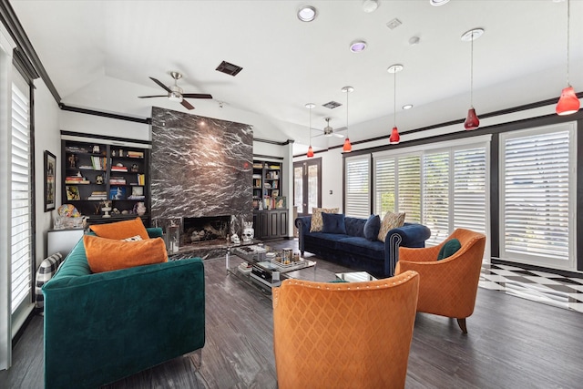 living room featuring ceiling fan, dark hardwood / wood-style flooring, a high end fireplace, and lofted ceiling