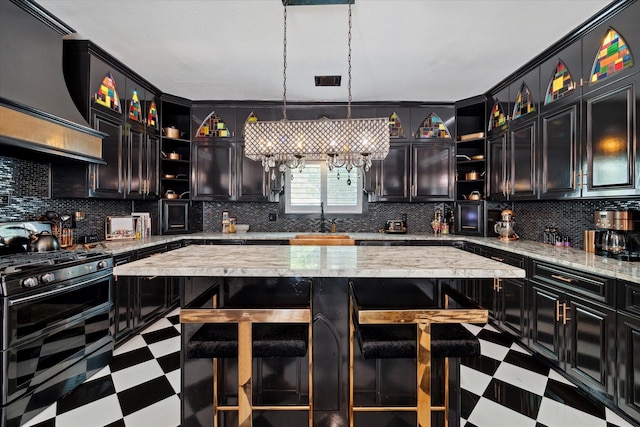 kitchen with decorative backsplash, a center island, double oven range, and decorative light fixtures