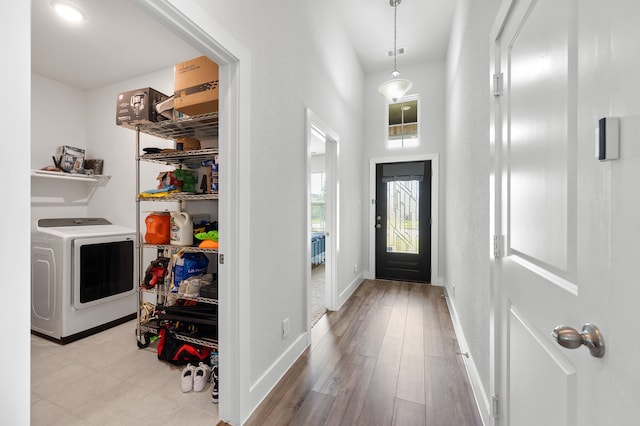 entryway featuring washer / clothes dryer and light hardwood / wood-style floors