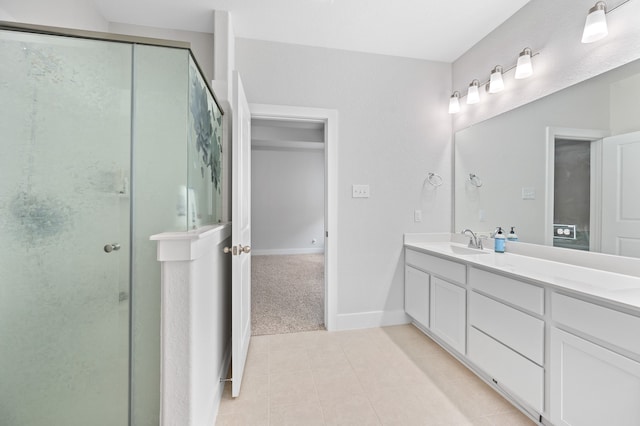 bathroom featuring tile patterned flooring, vanity, and a shower with shower door