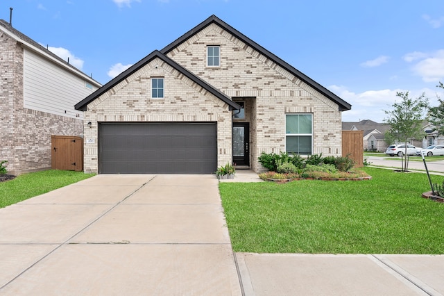 view of front of property with a garage and a front lawn