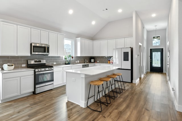 kitchen featuring dark wood-type flooring, stainless steel appliances, and white cabinets