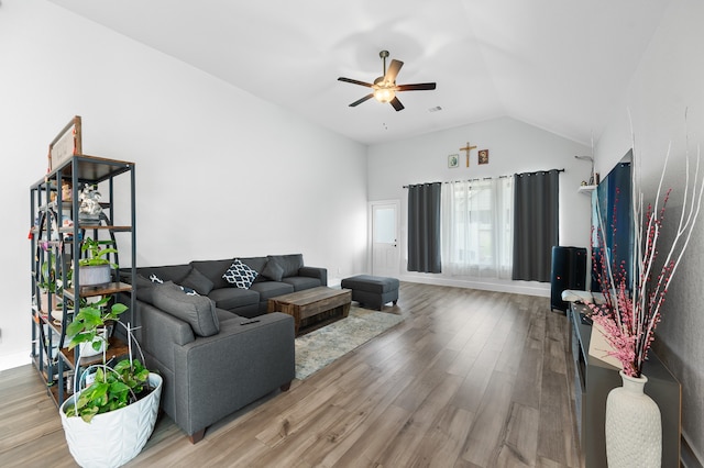 living room with ceiling fan, hardwood / wood-style flooring, and vaulted ceiling