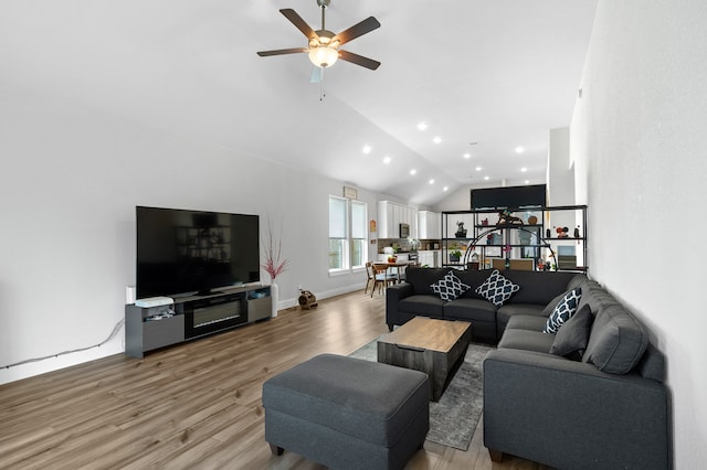 living room with vaulted ceiling, ceiling fan, and hardwood / wood-style flooring