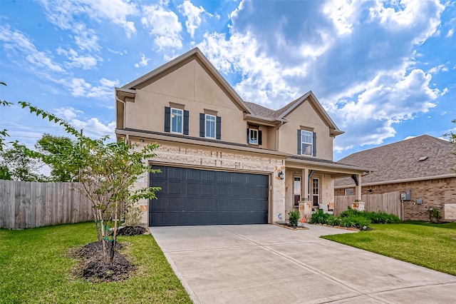 view of property featuring a front yard and a garage