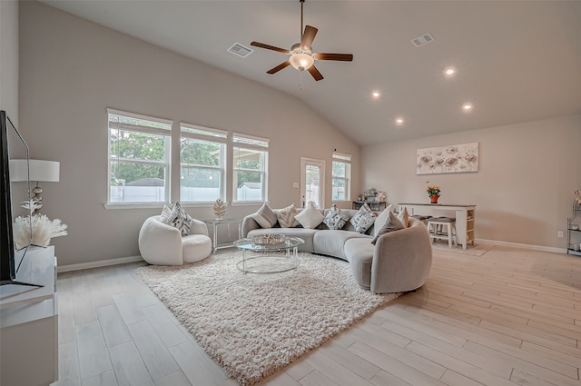 living room with light hardwood / wood-style floors, lofted ceiling, and ceiling fan