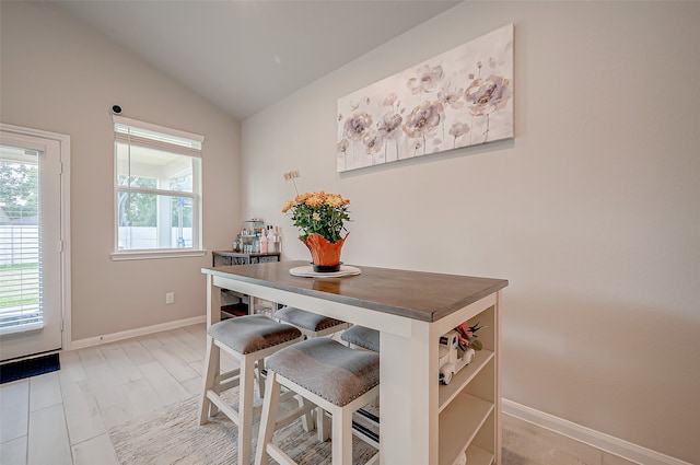 dining room with vaulted ceiling