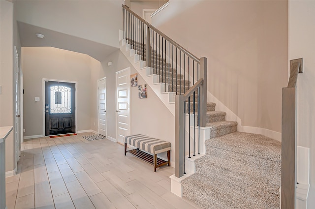 entryway featuring light hardwood / wood-style floors and a high ceiling