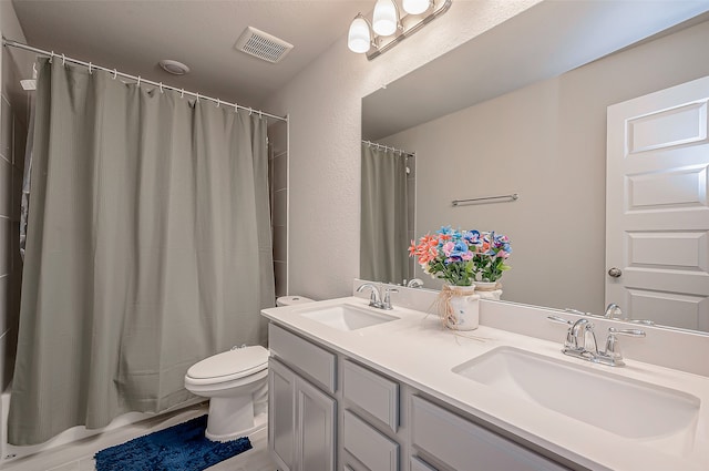 bathroom featuring walk in shower, vanity, and toilet