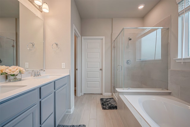 bathroom with vanity, separate shower and tub, and wood-type flooring