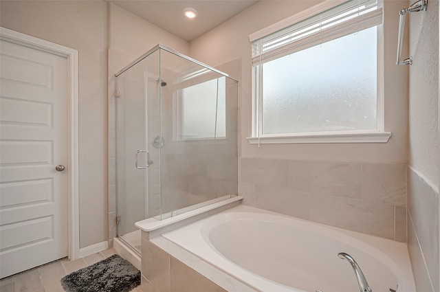 bathroom featuring tile patterned flooring and plus walk in shower