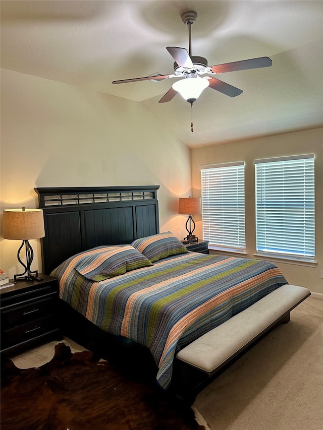 carpeted bedroom featuring lofted ceiling and ceiling fan