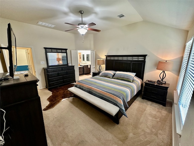 carpeted bedroom with ceiling fan, connected bathroom, and vaulted ceiling