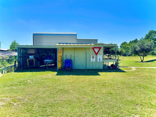 view of outdoor structure with a lawn and a carport